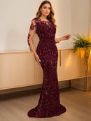 Burgundy sequin mermaid gown with floral details indoors