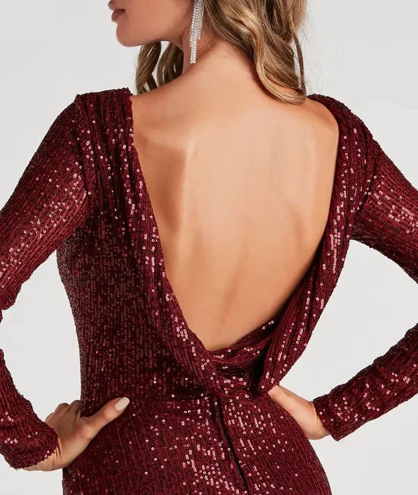 a woman wearing a red sequin dress with a backless neck