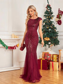 Burgundy mermaid sequin prom dress with cap sleeves, elegant fit.