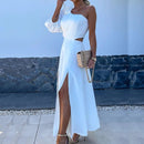 a woman wearing a white dress with a high slit