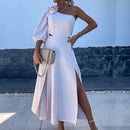 a woman wearing a white dress and heels