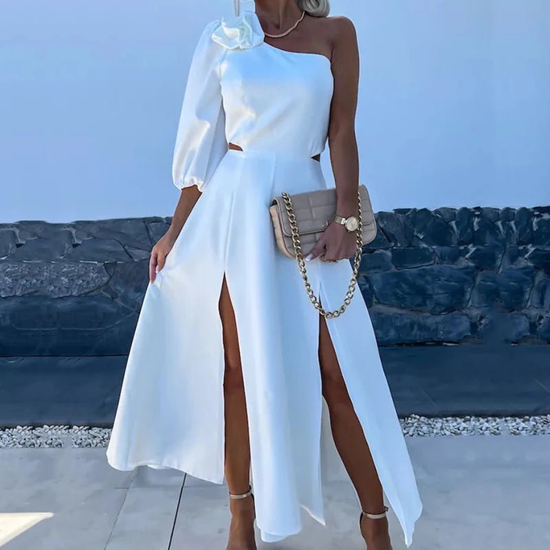 a woman wearing a white dress with a thigh high slit