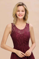 a woman in a maroon dress posing for a picture