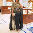 a woman standing in a store wearing a black and gold dress