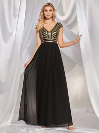 Elegant navy chiffon evening gown with cap sleeves and sequins.