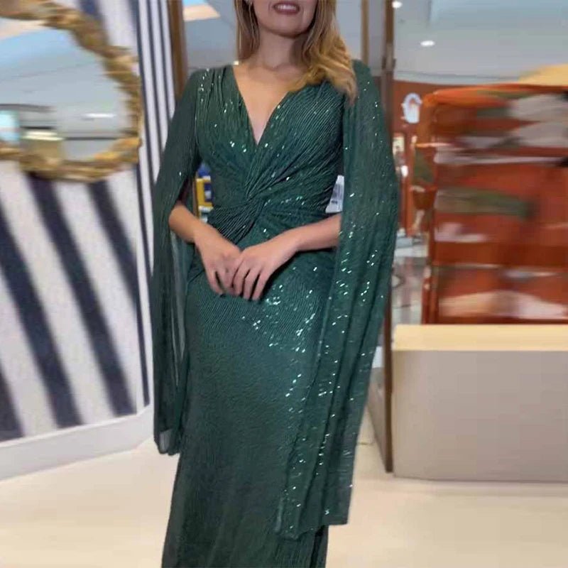 a woman in a green dress posing for a picture