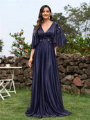 Elegant navy blue evening dress with flared short sleeves and floral appliqué.