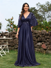 Elegant navy blue evening dress with flared short sleeves and floral appliqué.