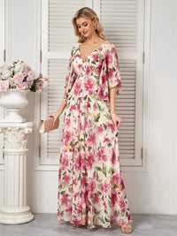 Floral chiffon maxi dress in pastel colors with short flared sleeves.