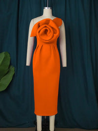 a mannequin wearing an orange dress with a flower on it