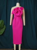 a mannequin wearing a pink dress with a flower on it