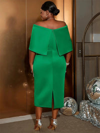 a woman in a green dress standing in front of a door