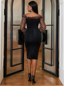 a woman in a black dress standing in a doorway