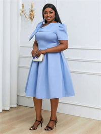 a woman in a blue dress posing for a picture