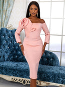 a woman in a pink dress standing in front of a couch