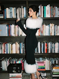 a woman standing in front of a book shelf