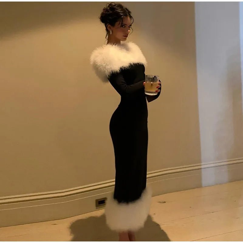 a woman in a black dress and white fur stole