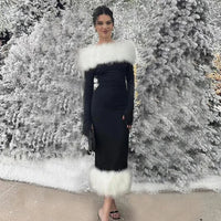 a woman standing in front of a snow covered tree