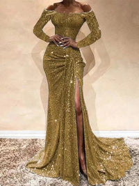 a woman in a gold gown with a slited skirt