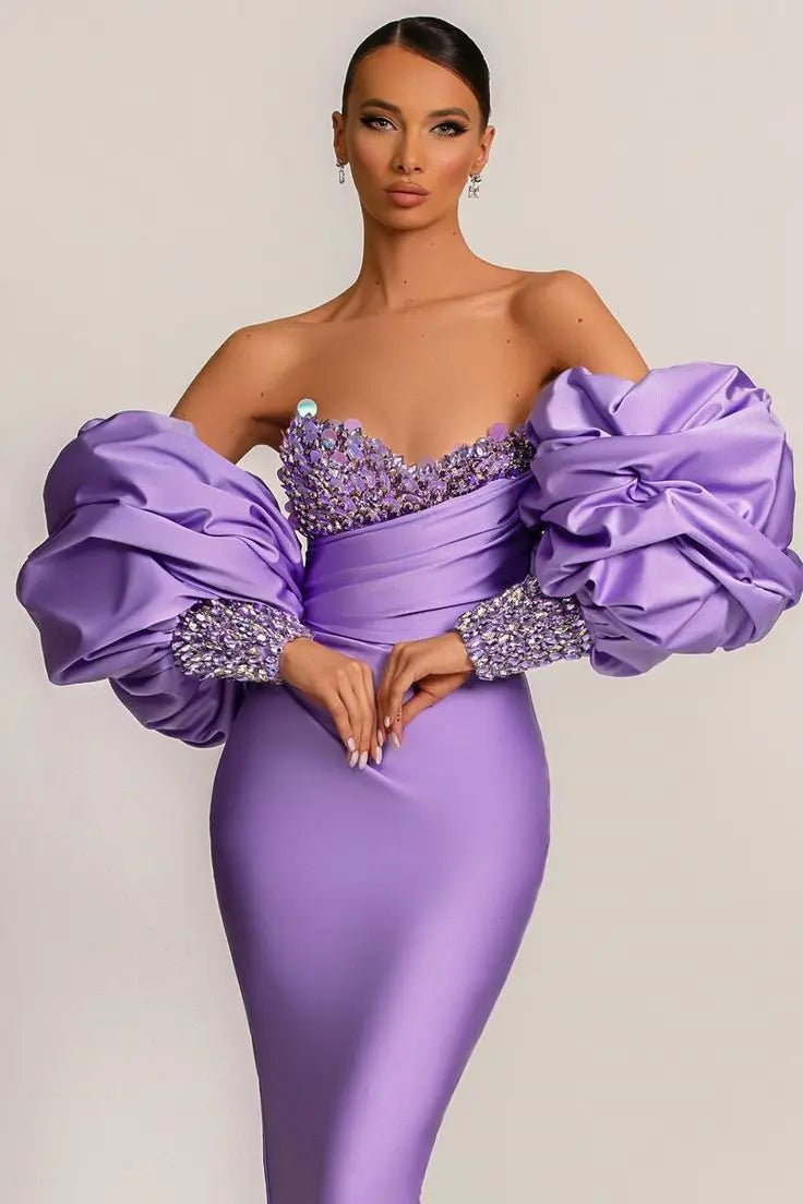 a woman in a purple dress posing for a picture