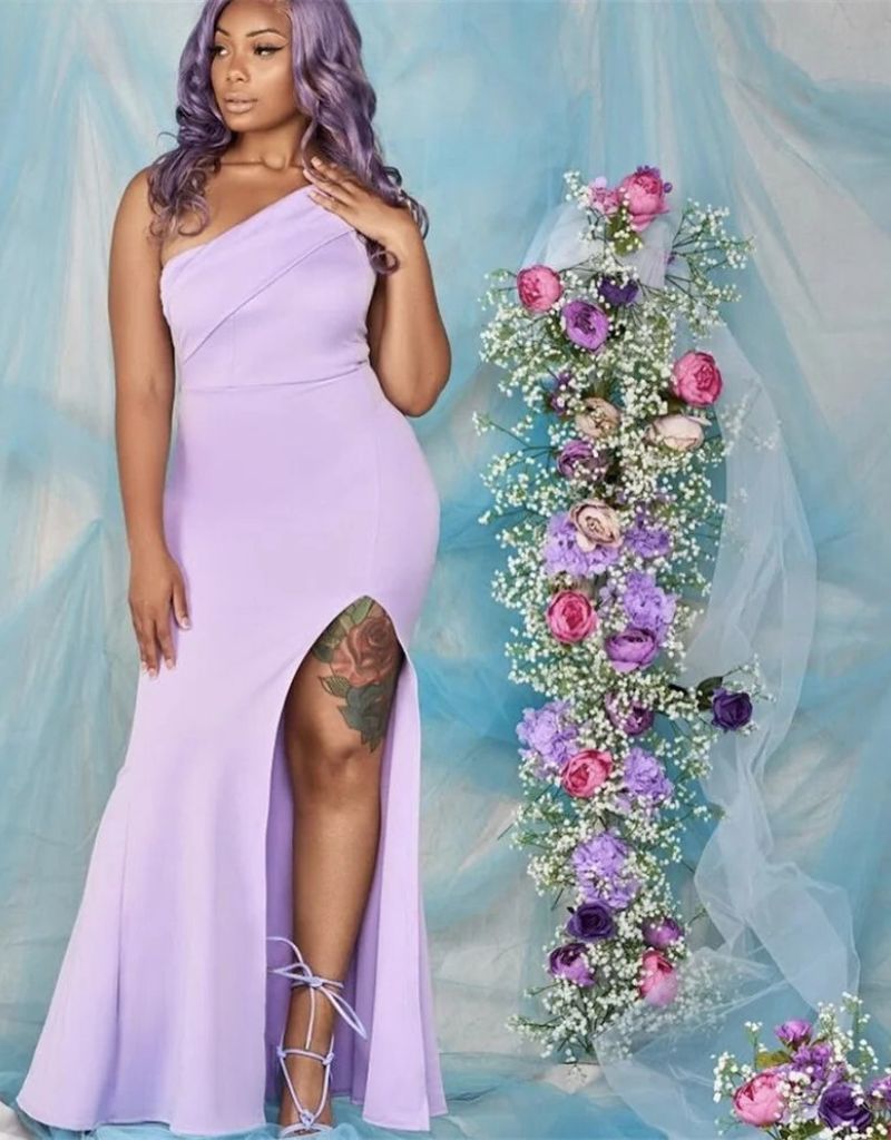 a woman in a purple dress posing for a picture