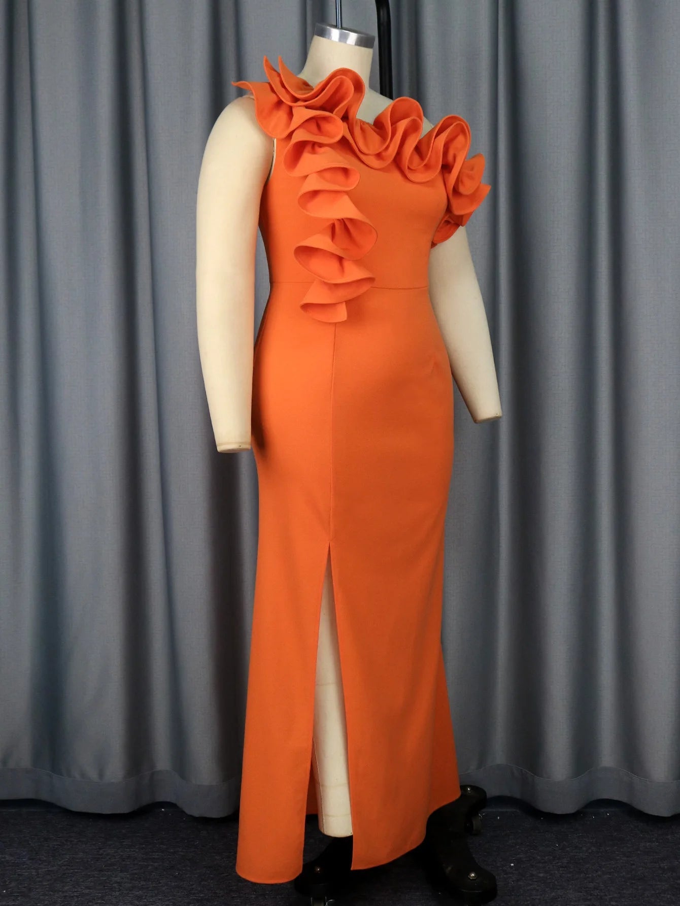 a mannequin wearing an orange dress with ruffles