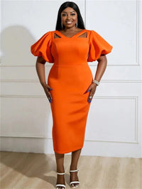 a woman in an orange dress posing for a picture