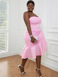 a woman in a pink dress posing for a picture