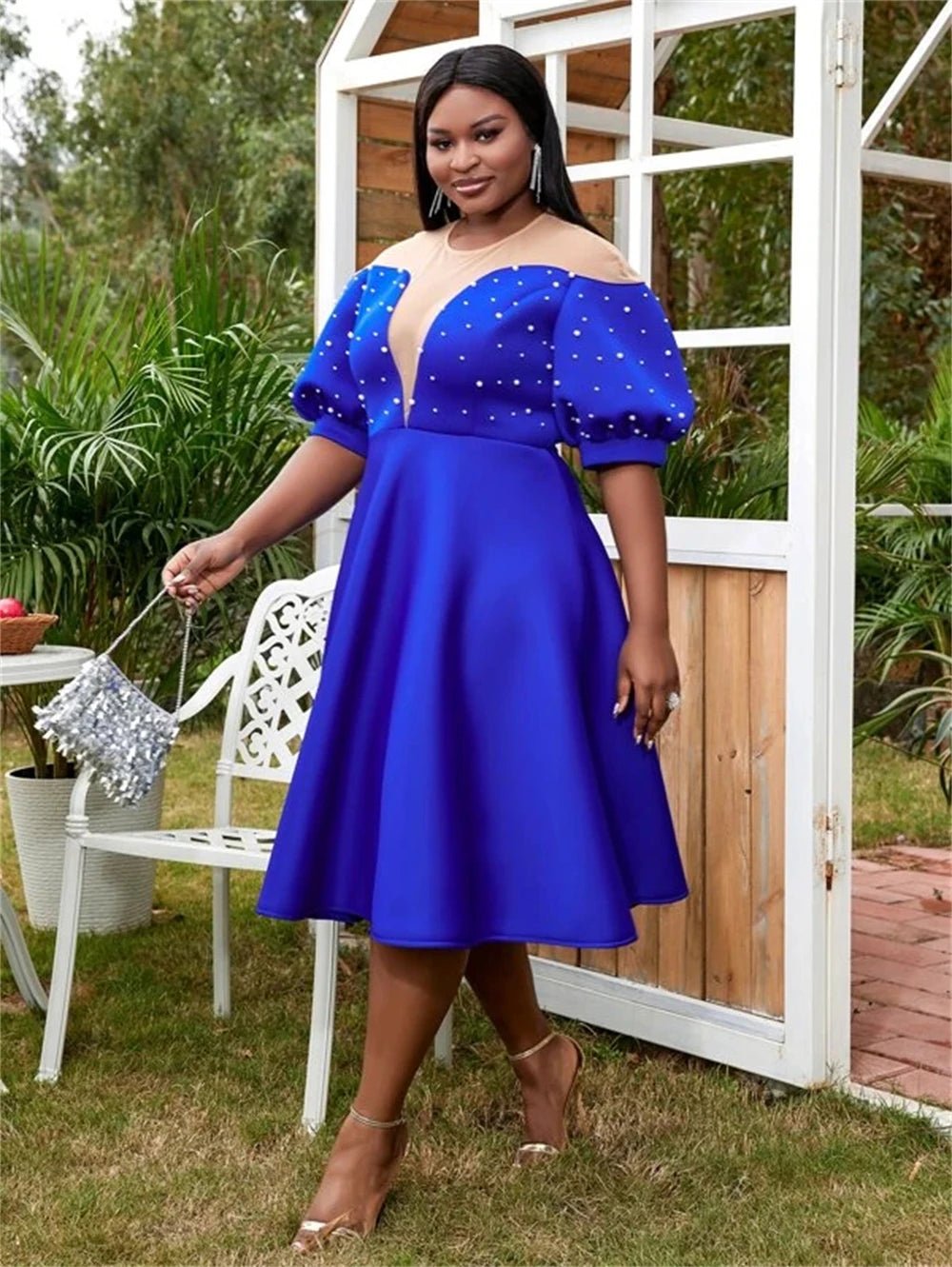 a woman in a blue dress posing for a picture