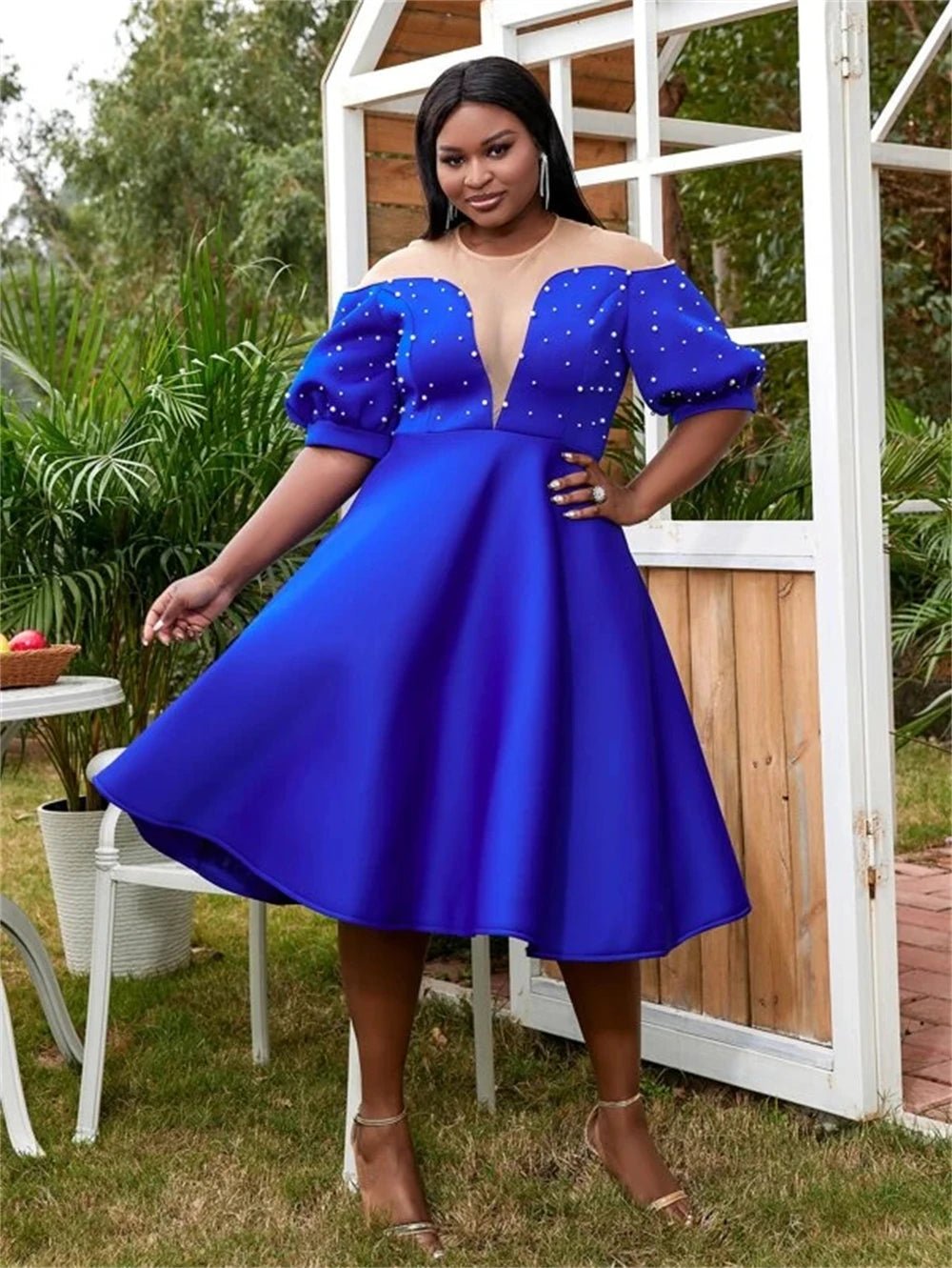 a woman in a blue dress posing for a picture