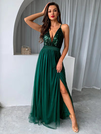 a woman in a green dress posing for a picture