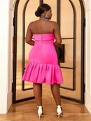 a woman in a pink dress standing in a doorway