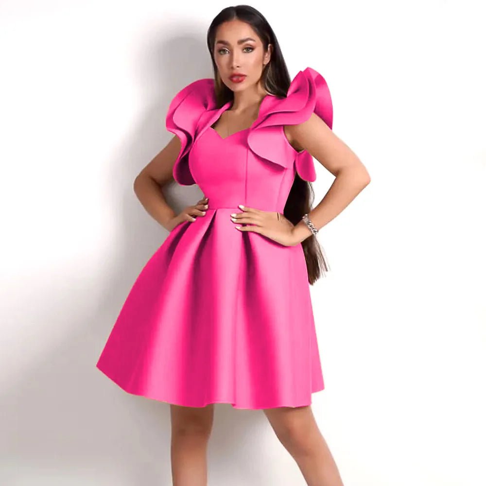 a woman in a pink dress posing for a picture