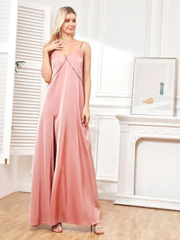 Elegant pink evening gown with side slits and spaghetti straps.