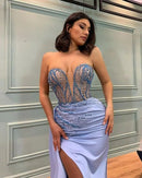 a woman in a blue dress posing for a picture