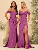 two women in purple dresses standing next to each other