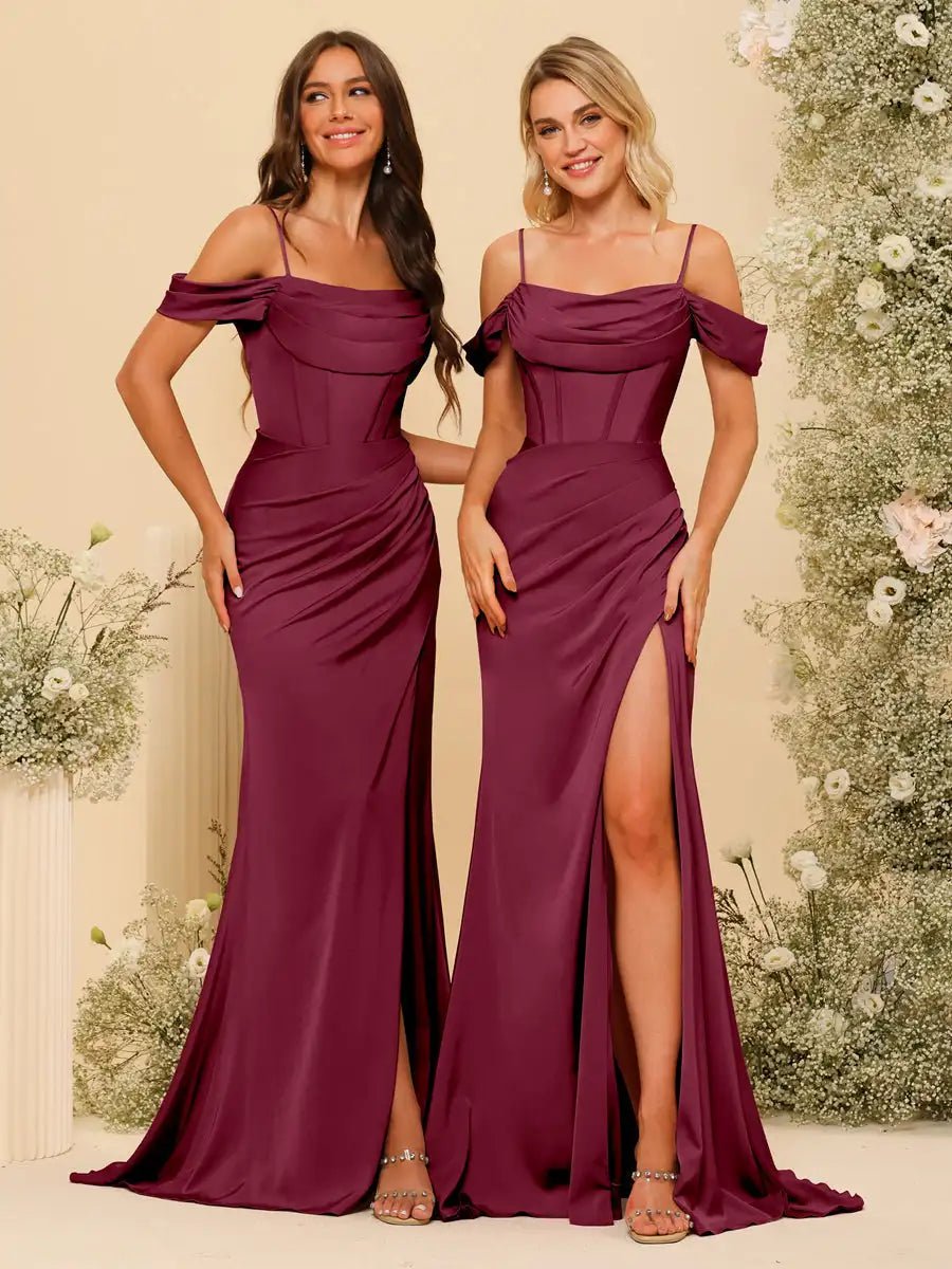 two women in long dresses standing next to each other