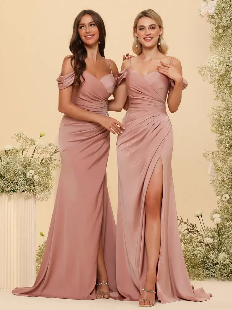 two women standing next to each other in dresses