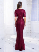 Back view of burgundy sequin mermaid formal dress