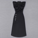 a black dress with a ruffled neckline and buttons