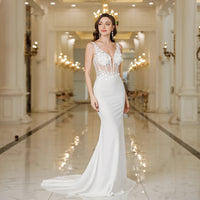 a woman in a white dress standing in a hallway