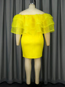 a mannequin wearing a yellow dress with ruffles