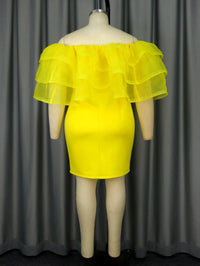 a mannequin wearing a yellow dress with ruffles