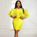 a woman in a yellow dress posing for a picture